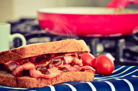 Bacon sandwich with brown sauce, instagram style filter applied for a retro feelの写真素材