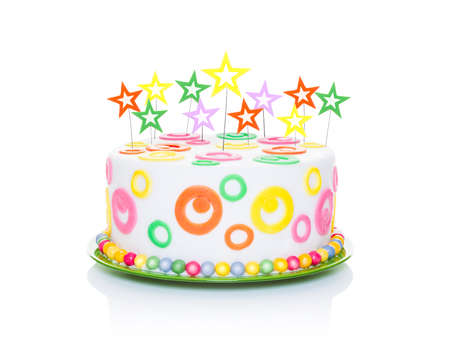 happy birthday cake or tart with star candles very colorful and looking very tasty, isolated on white backgroundの写真素材