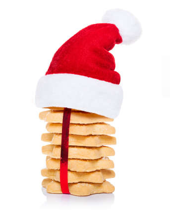 christmas cookies biscuits with santa claus hat, isolated on white backgroundの写真素材