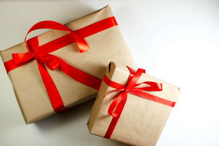 Classy Christmas gifts box presents on white background. Small Handmade gift boxes with red ribbonsの写真素材