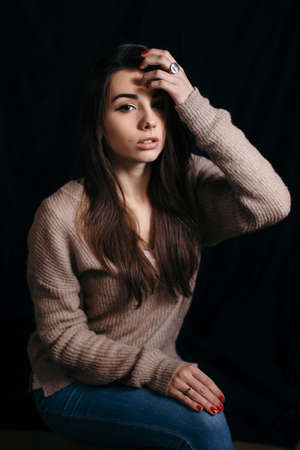 Beautiful brunette woman on black background. Close up of an attractive girl of European appearance.の写真素材