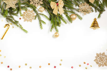 Christmas still life. Golden toys, spruce branches and decorative Christmas ornaments on a white background.の写真素材