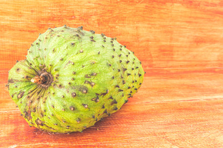 delicious green soursop in top of a wooden surfaceの写真素材