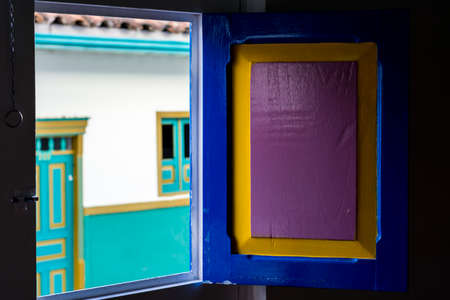 streets of the picturesque little town of Salento in Colombia through a window