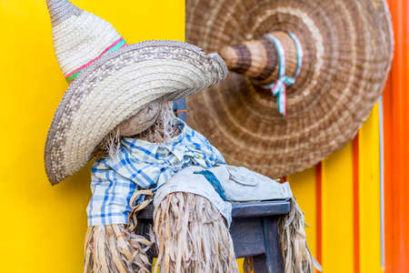 funny scarecrow seated in front of a store in Colombiaの写真素材