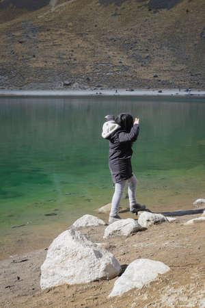 young woman in nature in a lakeの写真素材