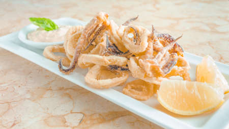 fried squid whit lemon appetizerの写真素材