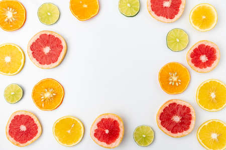 colorful slices of citric fruits on a white backgroundの写真素材
