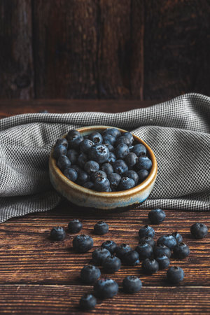 Blueberries in a bowl on a wooden background. Rustic style.の写真素材