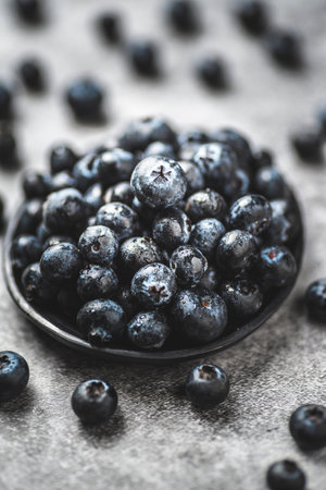 Fresh blueberries in a bowl on a gray background, selective focusの写真素材