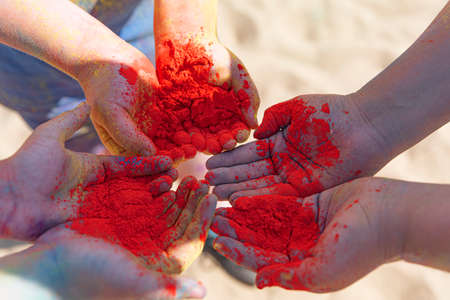 Close up of hands holding colored powder during Holi Festival. Enjoying and celebrating festival of colors. Hindu traditionの写真素材