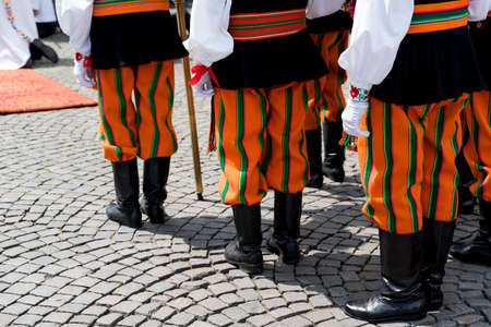 Group of men dressed in polish national folk costume from Lowicz region. Traditional colorful folk clothing. Polish cultureの写真素材