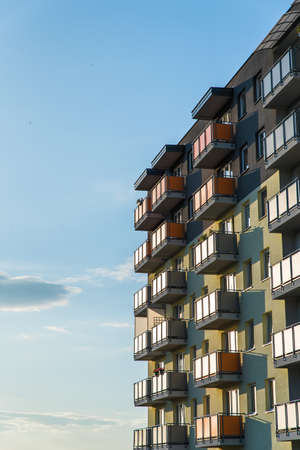 Poland, August 2020: Exterior of modern residential apartment building with balconies against blue sky. Urban landscape with block of flats. Real estate marketのeditorial素材