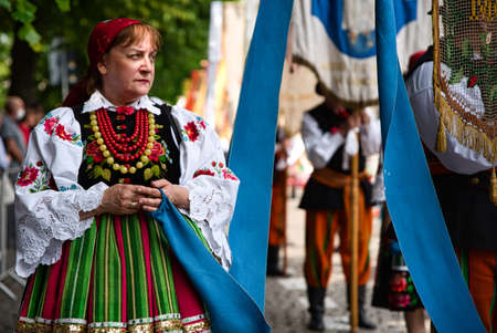 Lowicz, Jun 11, 2020: Woman dressed in polish national folk costume from Lowicz region during Corpus Christi procession. Polish typical folk dressのeditorial素材