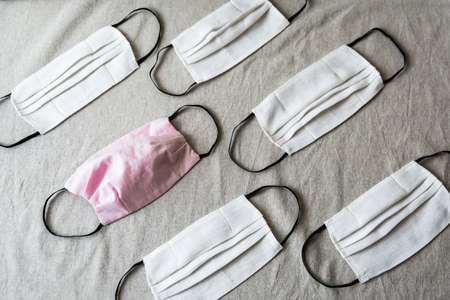 Homemade face protective masks on flat lay background. Reusable linen face masks against virus  flu