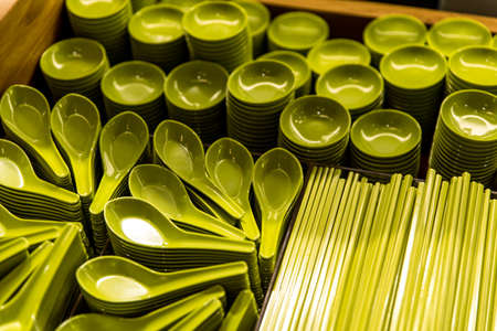 Set of green porcelain kitchen utensils. Miso soup spoons, soy sauce bowls and ceramic chopsticks
