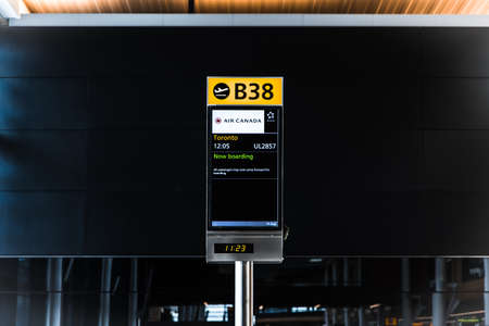 London, Heathrow Airport, Aug 2019: Gate B38 open for boarding. Flight announcement. Flying to...