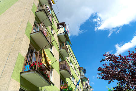 Green elevation and colorful facade of block of flats in housing estate. Housing block with laundryの写真素材
