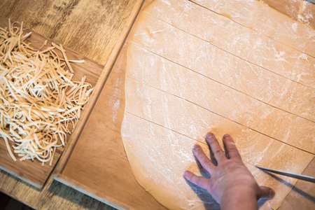 Woman preparing home made fresh pasta at homeの写真素材