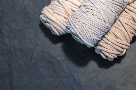 Top view of macrame cotton cords, natural cotton ropes on gray background