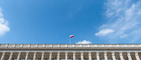 Flag of Poland waving in the wind against blue sky background. Polish National Flag Dayの写真素材