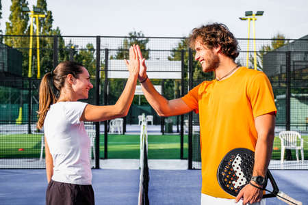 Portrait of handshake of two padel tennis players - Padel players embracing after win a padel matchの写真素材