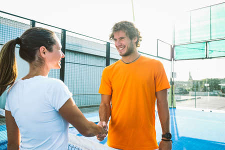 Portrait of handshake of two padel tennis players - Padel players embracing after win a padel matchの写真素材