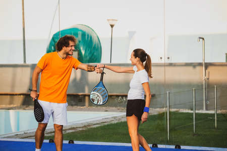 Two padel player greet each other doing fist bump - Padel friends say hello at the time of the covidの写真素材