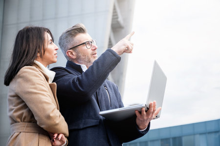 Business people looking away and bringing new business ideas in to life - Two workers standing and...