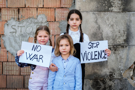 Children holding posters with written STOP VIOLENCE and NO WAR in support of peace. Concept of no war in Ukraine and in the world. Russian conflictの写真素材