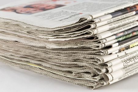 newspaper stack on white background