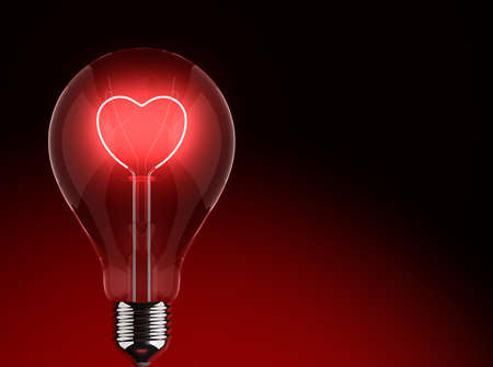 Heart shape in a light bulb on a black backgroundの写真素材