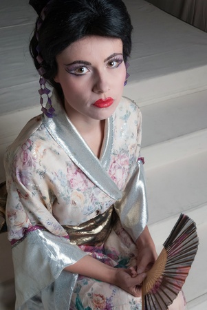 Traditional Japanese geisha woman with extreme makeup and traditional clothingの写真素材