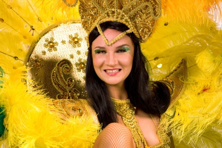 Portrait of young woman in yellow carnival costume, close up