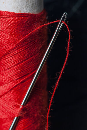 Close up of thread through a needle's eye