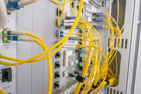 Patch panel of fiber optic network cables. Fiber optic installation in a rack