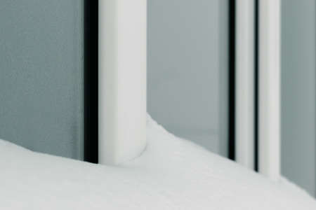 The window is snow-covered. There is a lot of snow outside. Winter does not go awayの写真素材
