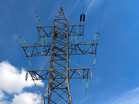 A High-voltage power line against the blue sky. High voltage electric transmission towerの写真素材