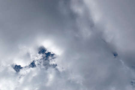 White cumulus clouds against a blue sky. Weather changes