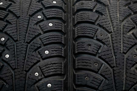 Car tires with traces of use. There are no spikes on one tire. The concept of proper driving by carの写真素材