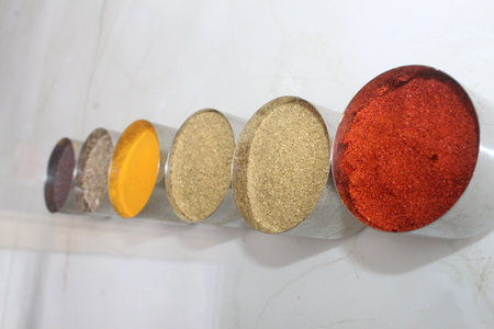 Spices in a glass container on a white marble countertop. Authentic Indian Spices are used in all the kitchens in India.の写真素材