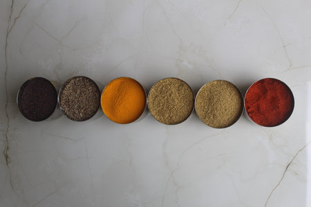 Spices in bowls on white marble background, top view, Authentic Indian Spices are used in all the kitchens in India.の写真素材