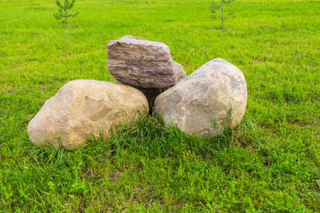 Pile of large stones on green grassの写真素材