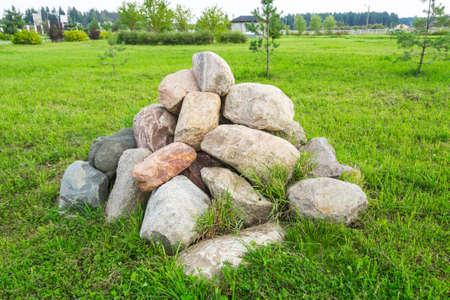 Pile of large stones on green grassの写真素材