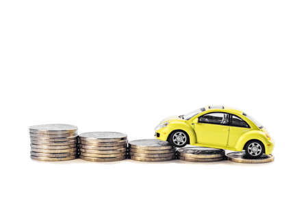 Car on the coins isolated on white background