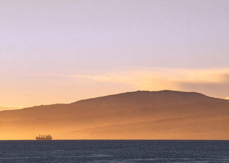 Container leaves port in beautiful morning light outside of Christchurch, New Zealandの写真素材