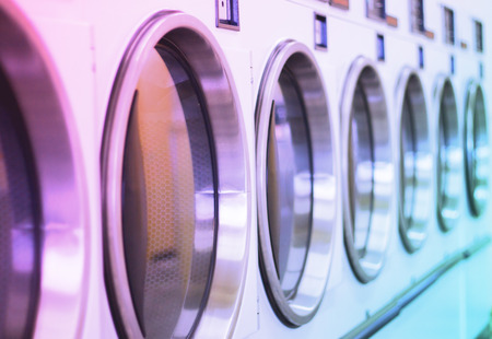 laundromat machine washer line with closed doors shallow depthの写真素材