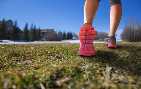 pair of legs walking up a big hill in early spring with a shallow depth of field with space for copyの写真素材