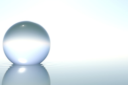 Zen glass sphere in zen water on white backgroundの写真素材