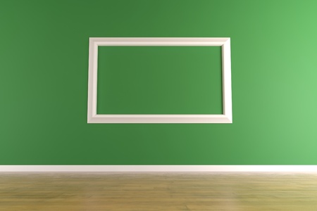 Empty and white picture frame isolated on a green wallの写真素材